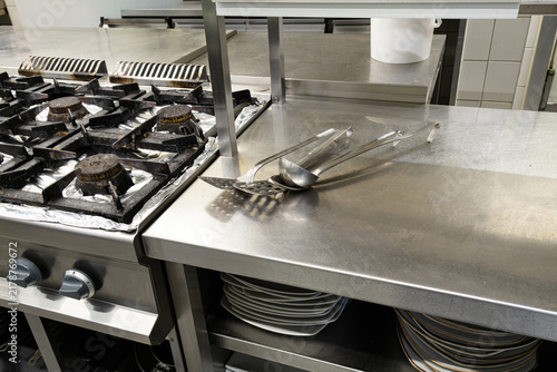 stainless steel commercial kitchen stove and utensils