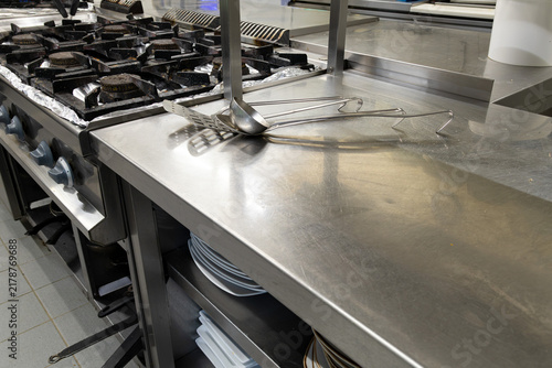 stainless steel commercial kitchen stove and workspace