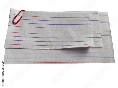 Stack of white paper sheets with red and blue vertical lines held together by a red metal paperclip office tool