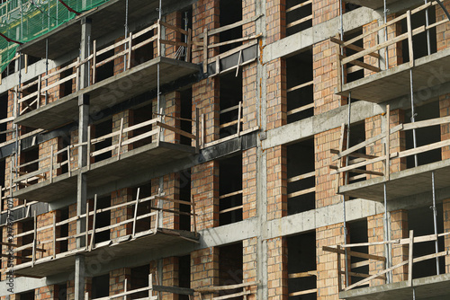Картината върху платно Unfinished residential apartment building has exposed brick walls concrete floors and temporary wooden railings