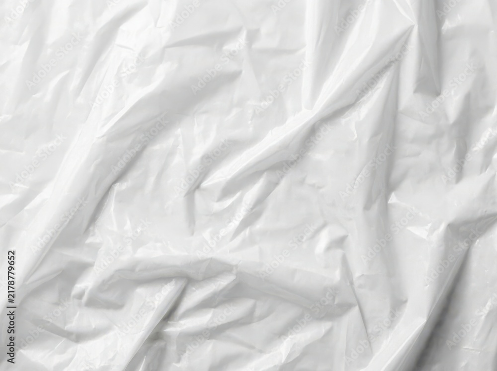 Obraz premium A close up view of white crinkled plastic sheet with soft shadows