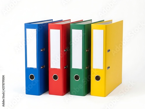 An isolated image of four vibrant ring binders with label holders on a white background