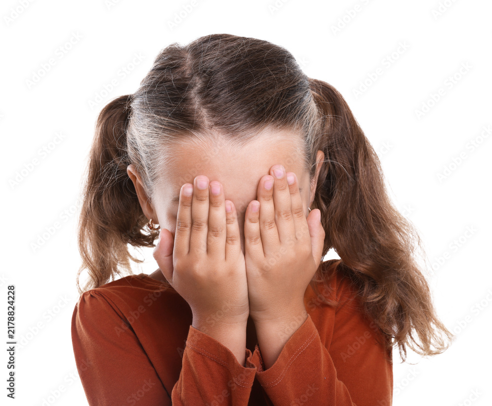 Fototapeta premium Stress. Scared little girl hiding her face on white background