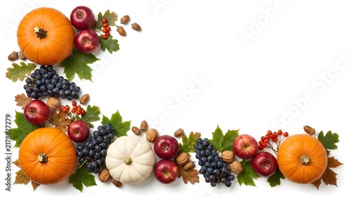 Autumn harvest corner border with orange and white pumpkins, red apples, dark purple grapes, acorns, and colorful fallen oak and maple leaves