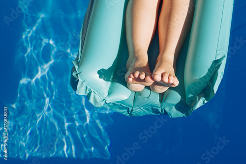 Young persons feet on a lilo