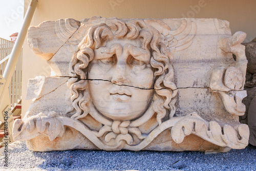 Принти на полотні Ancient marble Medusa relief with cracks at archaeological site, Medusa Gorgon f