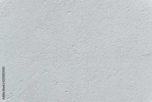Full-frame texture of a light grey exterior stucco plaster wall.
