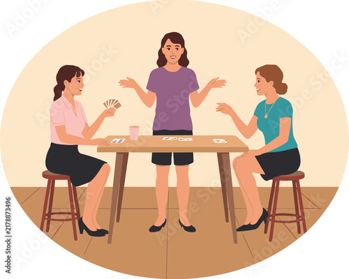 Three women sitting and standing around a wooden table playing card games together in a friendly social setting