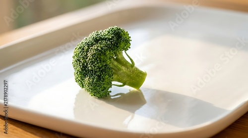 Fresh Green Broccoli Floret on White Plate in Bright Kitchen