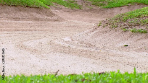 Background of two sand trap mounds on a golf course.