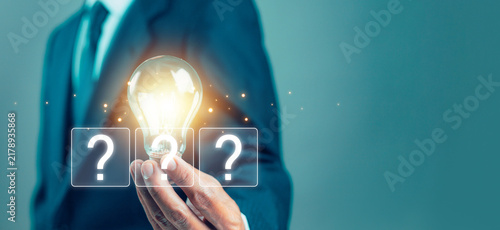 Konstfotografi Creative business concept featuring a glowing light bulb held by a professional, symbolizing innovation, ideas, problem solving, creativity, opportunity, strategy, inspiration, and decision making