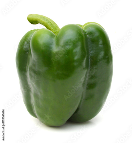 Green bell pepper in a bowl on white background