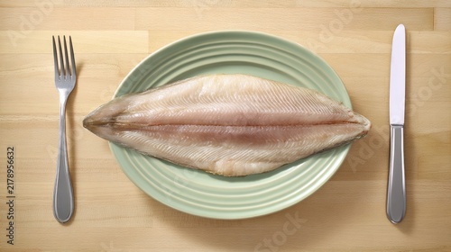 Freshly cooked golden-brown walleye fillet on ceramic plate, clean wooden countertop, healthy meal concept