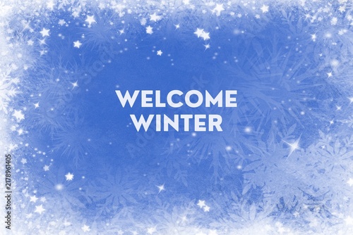 Welcome winter text typography over snowy snowflake blue winter background with snowflake