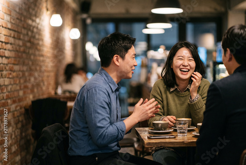 Korean Colleagues Enjoying Relaxing Coffee After Work in Cafe