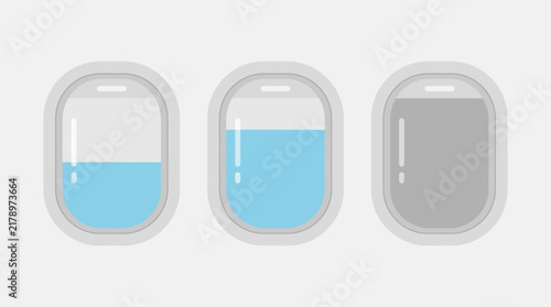 Row of three airplane window panels in a cabin with blue sky outside, travel and aviation concept