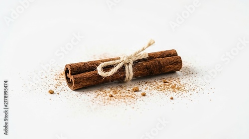 Aromatic Cinnamon Sticks Tied with Twine on White Background