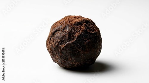 Close-Up View of Rich Chocolate Ball Coated with Cocoa Powder on White Surface