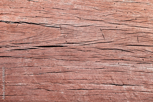 Quadro su tela Closeup textured view of weathered reddish-brown wooden plank texture with deep horizontal cracks and visible grain patterns