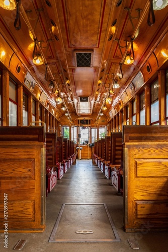 Фотография Vintage wooden trolley car interior with empty wooden seats