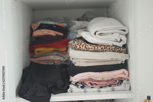 Bild auf Leinwand Clothing stacked neatly in a closet shelf