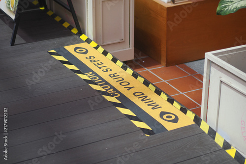 Caution sign on the floor warns about steps ahead