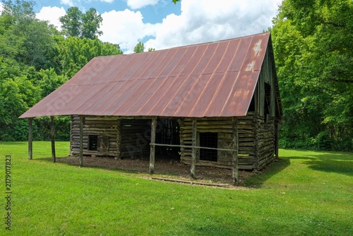 Rustic Log Barn with Weathered Metal Roof in Arkansas