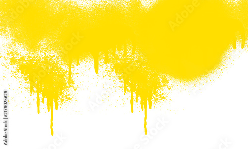 Fotografie Yellow spray paint texture with drips isolated on white background