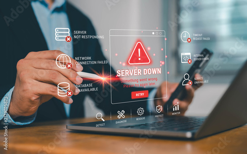 Business professional using laptop and smartphone with virtual server down alert, network failure and database error icons, illustrating website outage, IT troubleshooting and system monitoring.