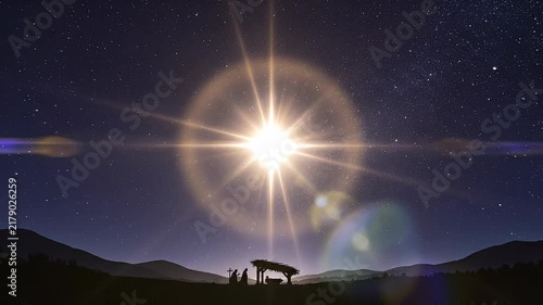 Nativity scene under starry night sky with bright glowing star over mountains landscape