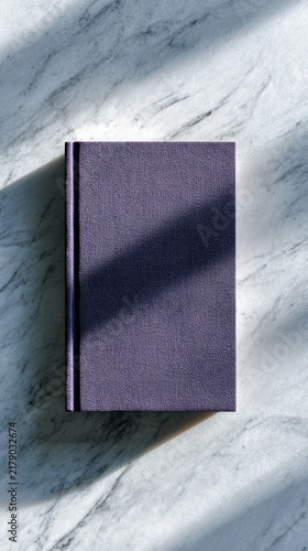 Purple book on marble surface