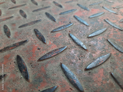 Fotografie Perspective view of a rusty diamond steel plate with a weathered red surface