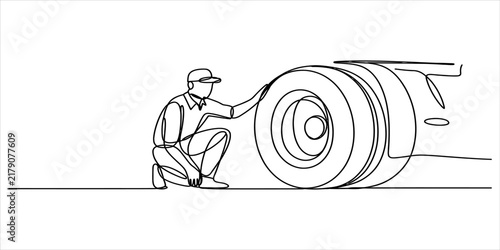 Continuous single line drawing of a mechanic man checking a large truck wheel tire in a garage for maintenance and repair service safety inspection