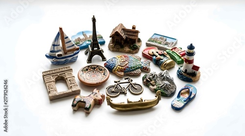Collection of colorful travel souvenirs and miniature tourist magnets on white
