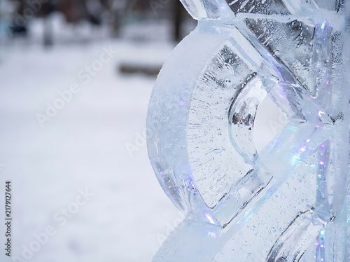 Intricate ice sculpture of swan glistening at snowy winter festival event display