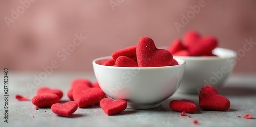 Tiny red hearts nestled amongst elegant white porcelain bowls , valentines, heart