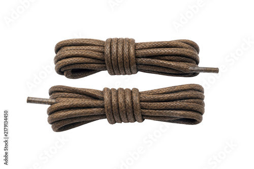 Quadro su tela Two neatly coiled brown braided shoelaces with metal aglets are precisely arrang