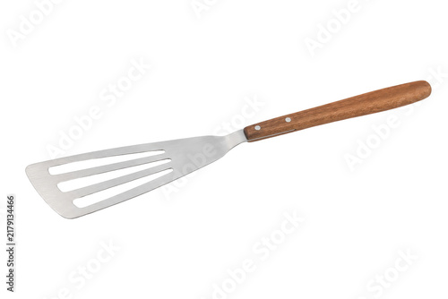 Cuadro en lienzo Shiny stainless steel slotted spatula with a natural wooden handle is isolated o