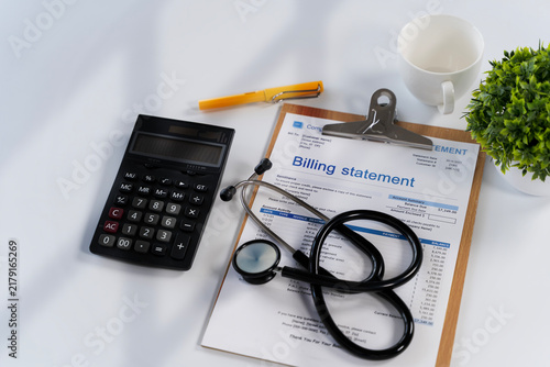 Medical Billing Statement with Stethoscope and Calculator on Office Desk