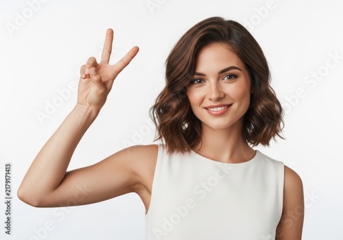 Woman making peace sign with hand and smiling