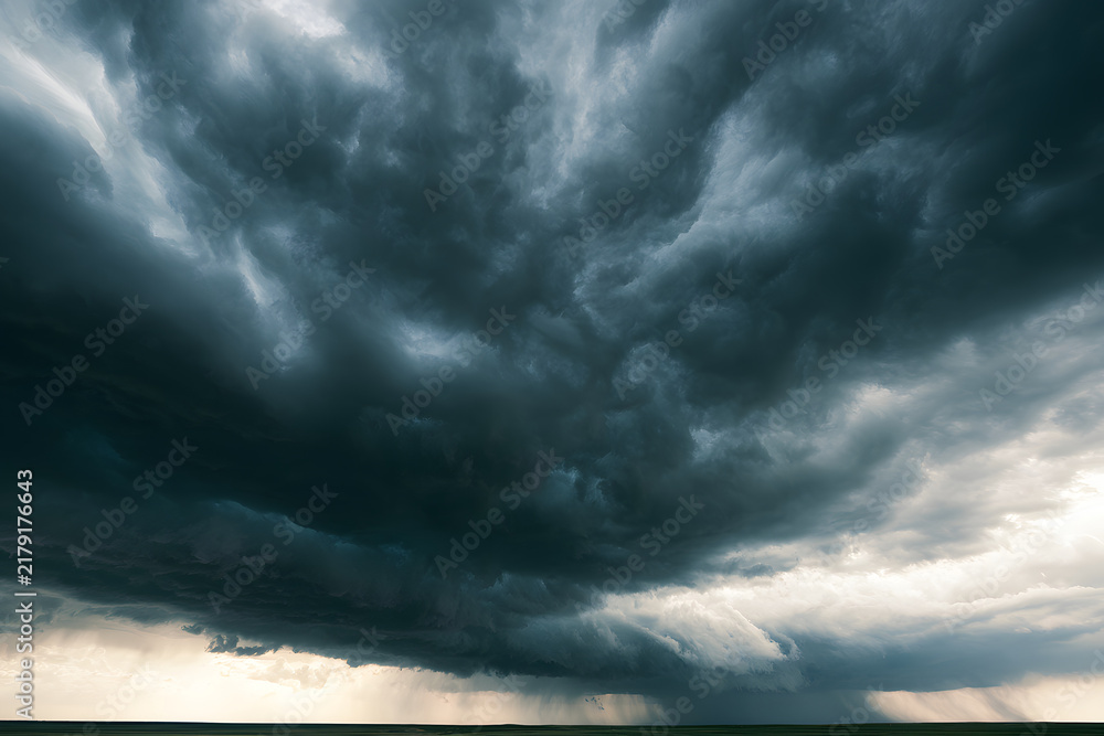 Obraz premium Overcast sky with dark storm clouds stretching across a flat horizon, accompanied by heavy rain. A scene highlighting severe weather conditions, the supremacy of nature, concerns about climate change,