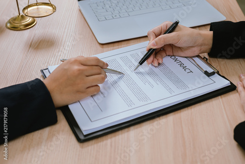 Konstfotografi Business professionals reviewing and signing a contract document, representing legal agreements, corporate negotiations, business partnerships, and financial transactions