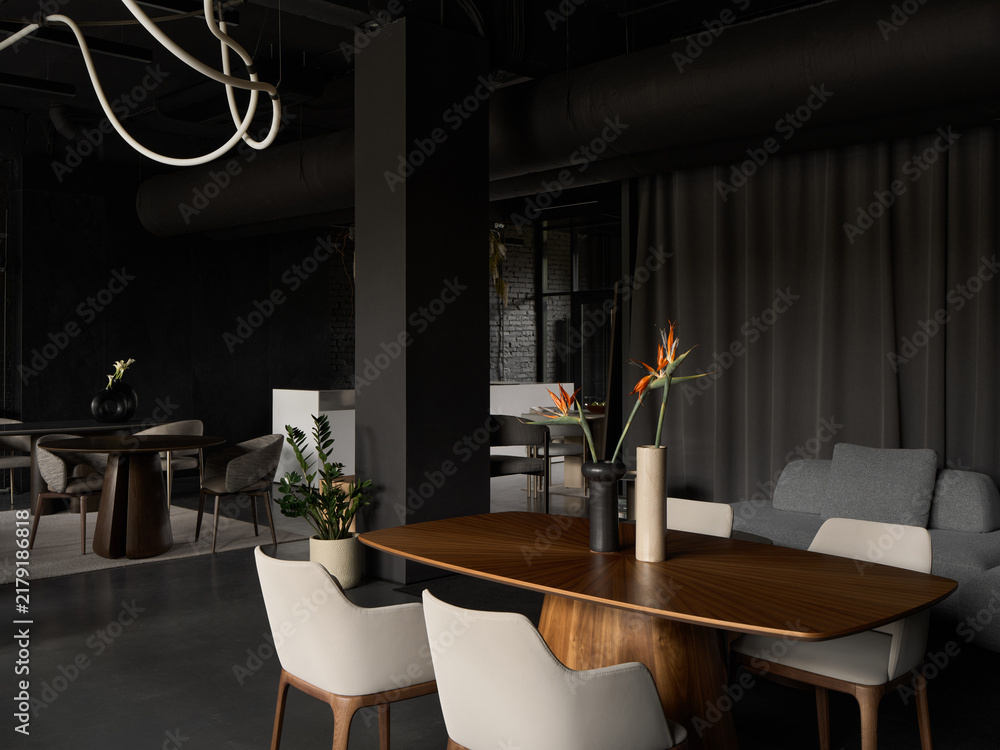Obraz premium Moody dark interior with modern furniture and flowers