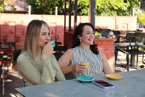 Two friends Enjoying Coffee at outdoor cafe