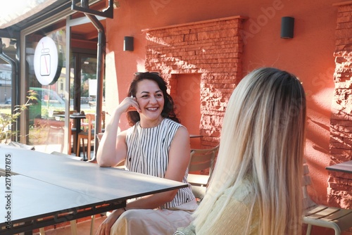 Two friends Enjoying Coffee at outdoor cafe