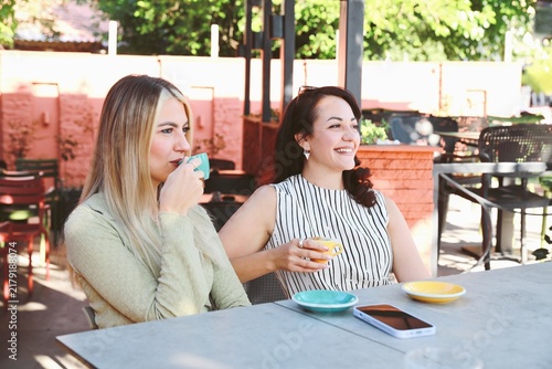 Two friends Enjoying Coffee at outdoor cafe
