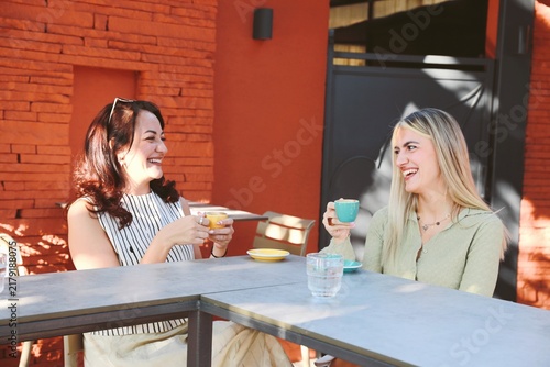 Two friends Enjoying Coffee at outdoor cafe