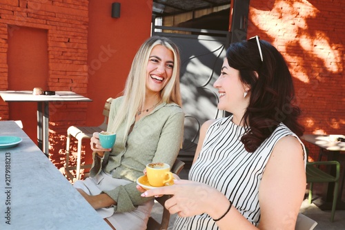 Two friends Enjoying Coffee at outdoor cafe