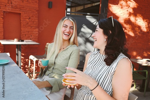 Two friends Enjoying Coffee at outdoor cafe