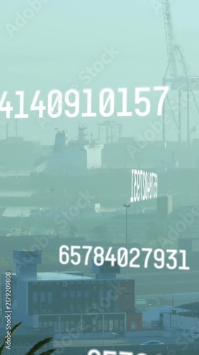Animation of changing numbers and computer language over fog covered modern city